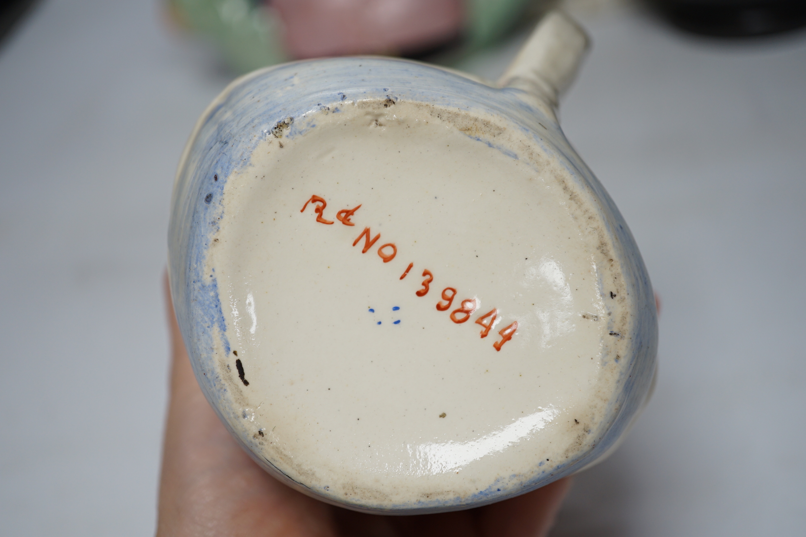 A Capodimonte figure, a Staffordshire pottery teapot, a jug and a Beswick pig